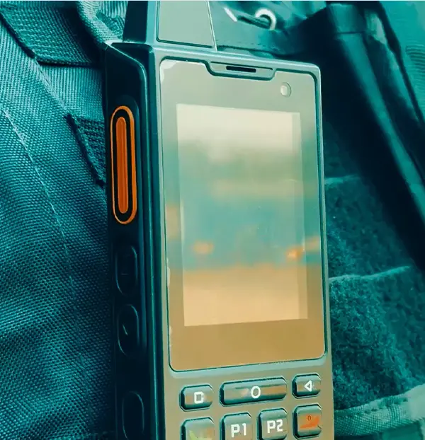 Trifokal 2-Way Radio clipped to a security guard's tactical vest